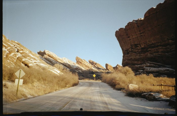 Winding road through red rock formations in winter