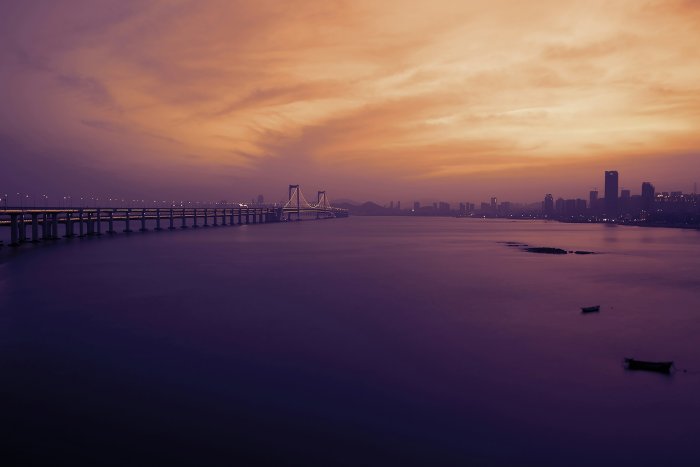 Xinghai Bay Bridge and Dalian Skyline at Sunset