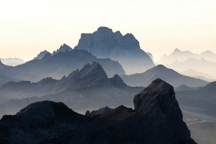 Layered mountain peaks shrouded in morning mist