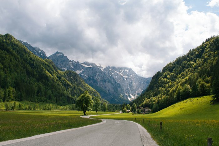 Winding road through a lush green mountain valley