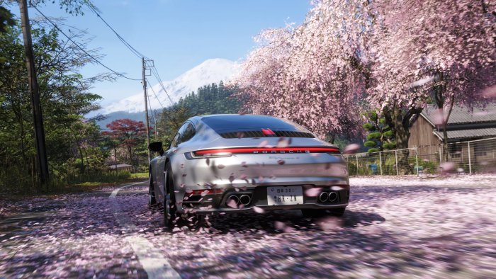 Silver Porsche 911 Driving Under Cherry Blossoms