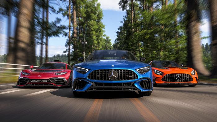 Three Mercedes-AMG Sports Cars Driving on Forest Road