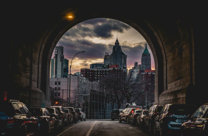 New York City skyline framed by stone archway