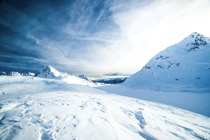 Snowy mountain landscape under a blue sky