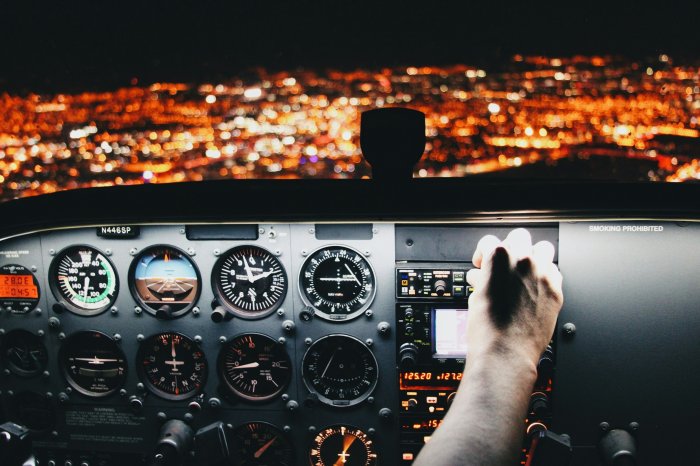 Airplane Cockpit Instrument Panel Flying Over City at Night