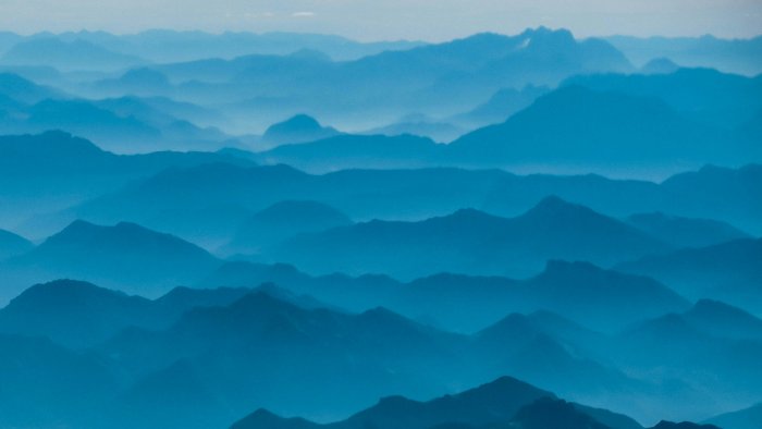 Layered blue mountain ridges shrouded in mist