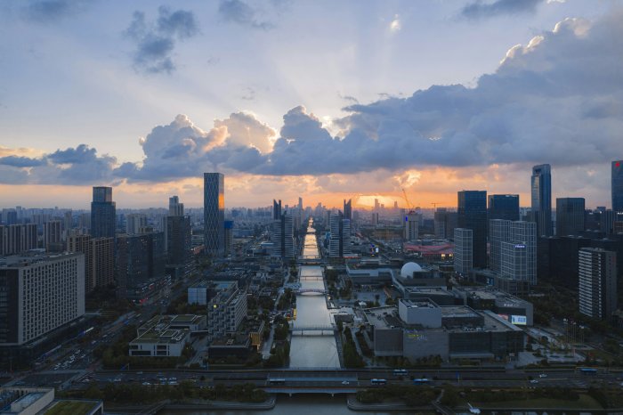 Modern City Skyline with Central Canal at Sunset