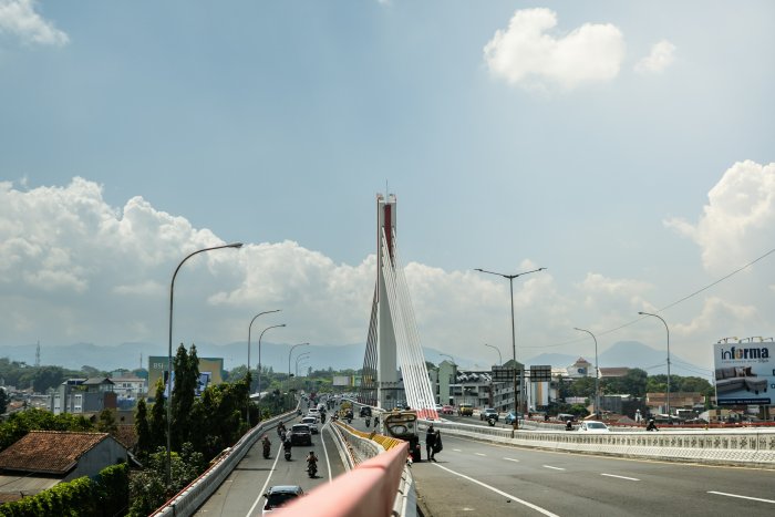 Modern cable-stayed bridge over a busy highway