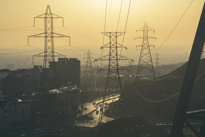Power transmission towers overlooking a hazy city