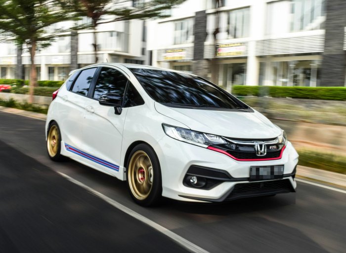White Honda Fit GK5 Hatchback Driving on Road