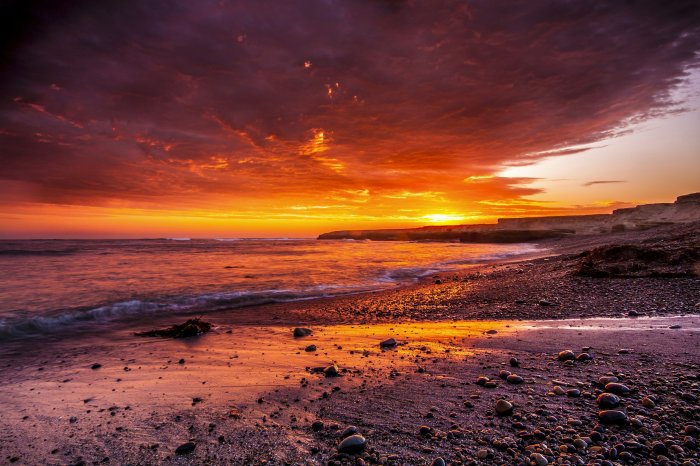 Fiery sunset over a rocky beach