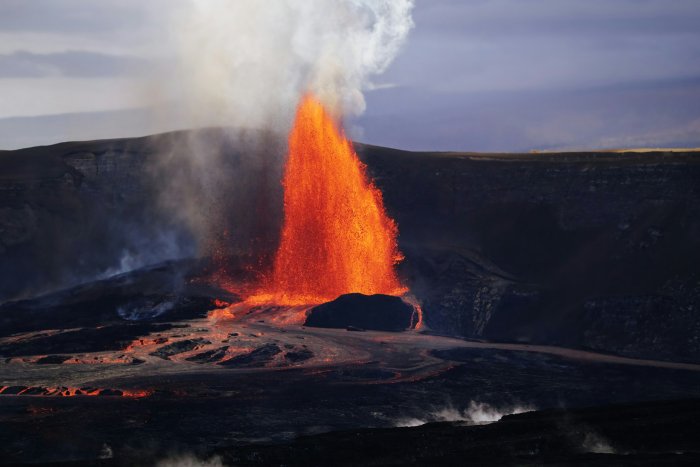 Volcanic eruption with bright orange lava fountain