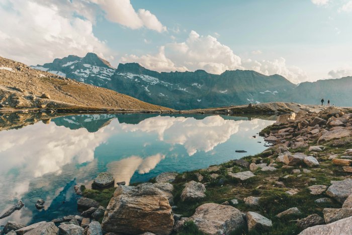 Alpine Lake Reflecting Mountains and Sky in Italy