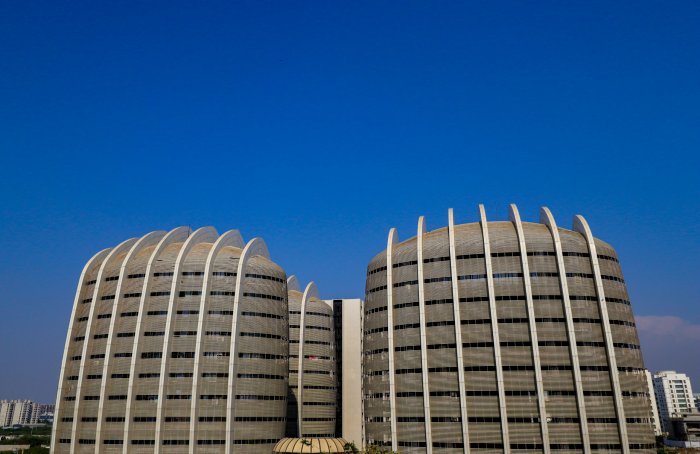 Modern curved architectural buildings under a clear blue sky