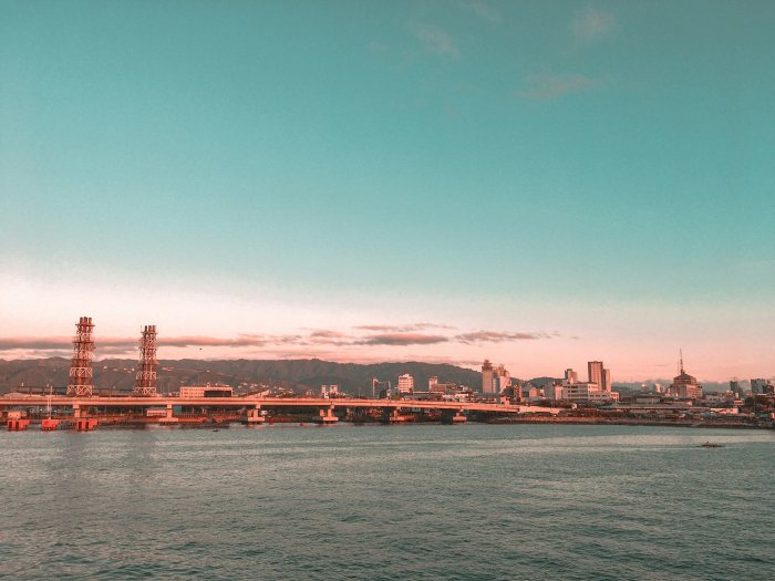 Coastal City Skyline with Bridge at Sunset