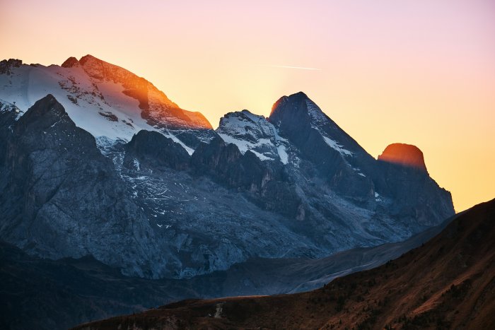 Sunlight shining on snow-capped Alpine mountain peaks