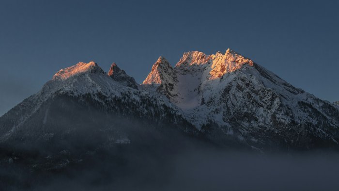 Snow Covered Mountain Peaks Glowing in Golden Sunlight