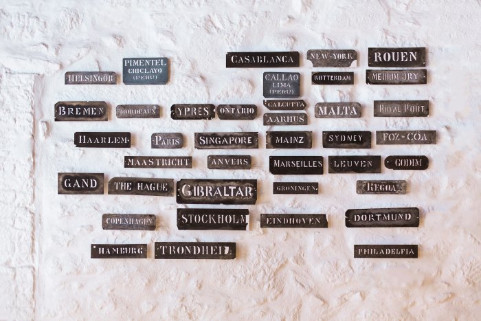 Vintage Export Plates with City Names on White Wall