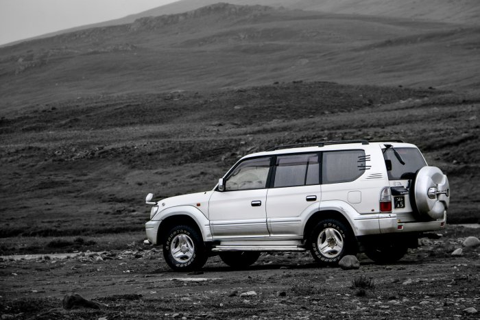White Toyota Land Cruiser Prado SUV in Mountainous Landscape