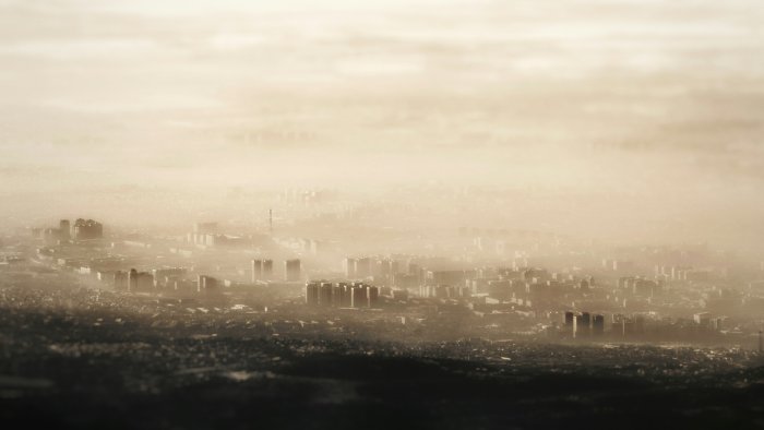 Hazy city skyline shrouded in thick fog
