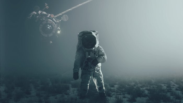 Astronaut standing on foggy ground with floating spacecraft