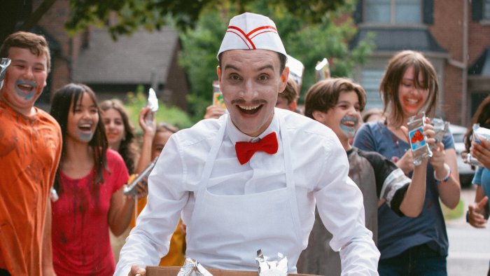 Ice Cream Man movie scene with smiling vendor and children