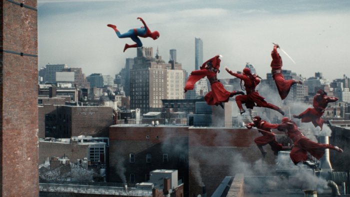 Spider-Man fighting red ninjas on city rooftops