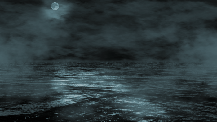 Dark misty ocean at night under a full moon