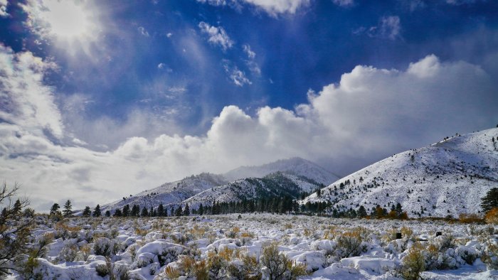 Snow Covered Mountains and Valley Under Blue Sky