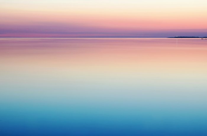 Calm sea with pink and blue sunset gradient
