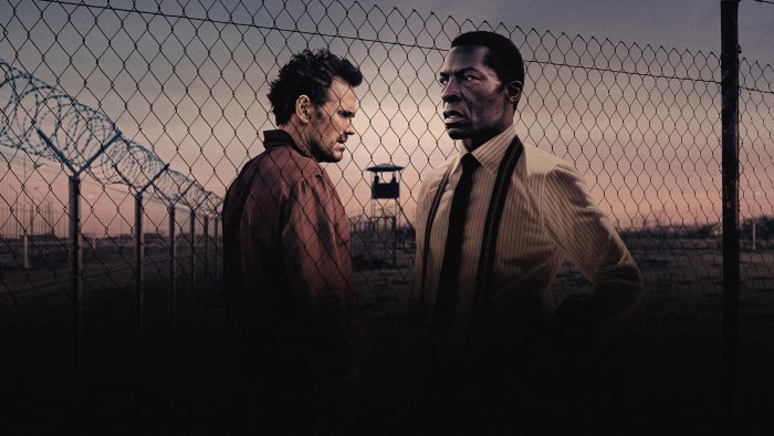 Two men facing each other in The Fence