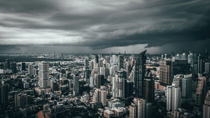 Aerial view of a dense city under storm clouds