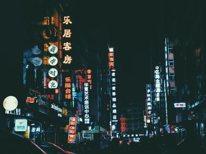 Chinese city street at night with neon signs