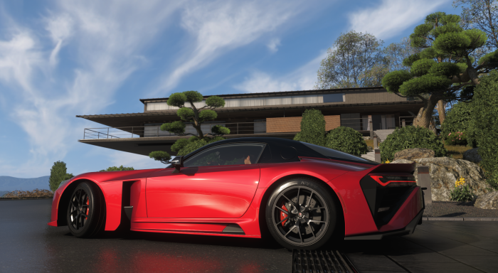 Red sports car parked near modern house