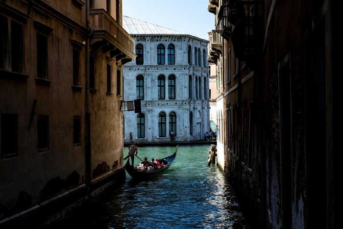 Gondola navigating a narrow canal in Venice