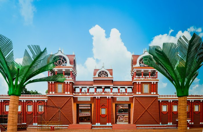 Red and Brown Architectural Gateway with Artificial Palm Trees