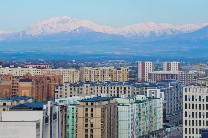 City Skyline with Snow Capped Mountains in the Distance
