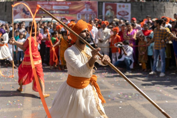 Man Performing with Staff at Shiv Jayanti Festival