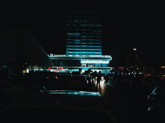Illuminated city building and street at night