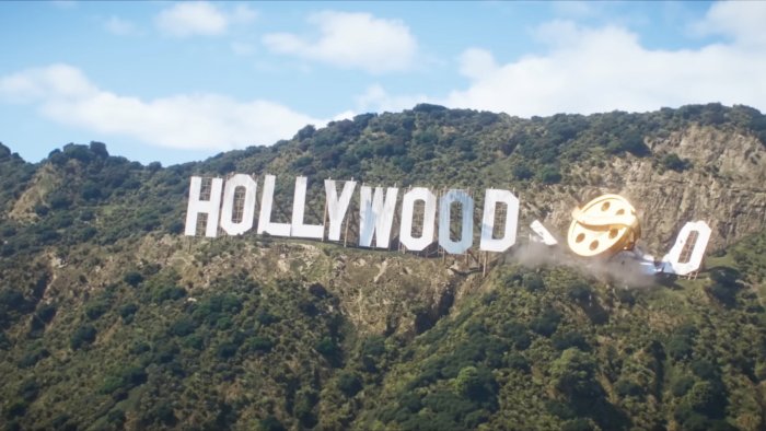 Golden Minion film reel crashing through the Hollywood sign