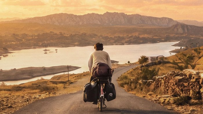 Man riding a bicycle in The Cycle of Love