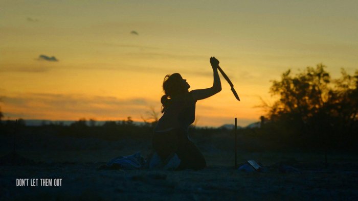 Woman holding a knife in Don't Let Them Out