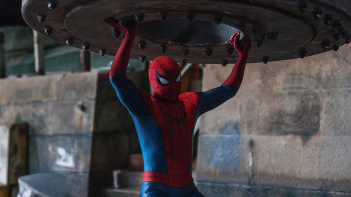 Spider-Man holding up a heavy metal structure