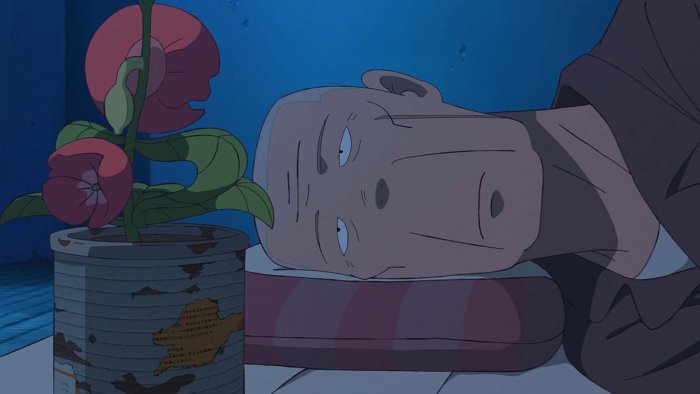 Man lying next to a flower in The Last Blossom