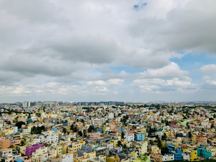 Aerial view of a colorful city under a cloudy sky