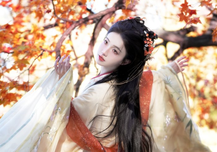 Woman in Traditional Chinese Hanfu with Autumn Leaves