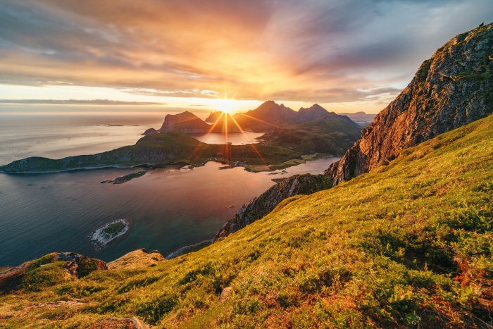 Sunset over coastal mountains and grassy hills