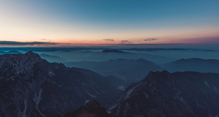 Mountain peaks above fog at sunset