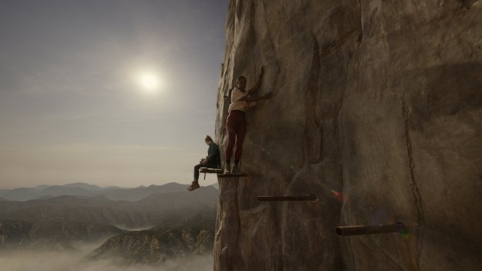 Climbers on a sheer cliff face in Fall 2: Deadpoint