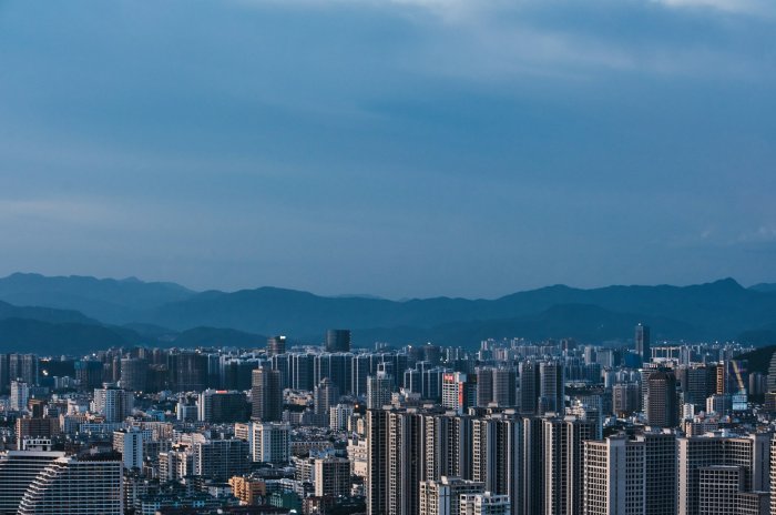 Dense City Skyline with Mountains in the Background